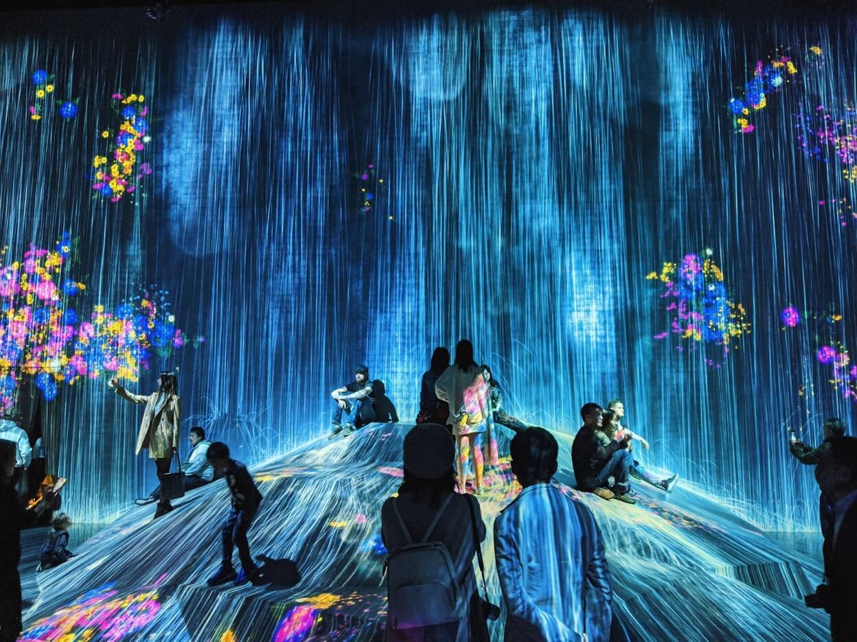 Visitors inside a teamLab digital art installation