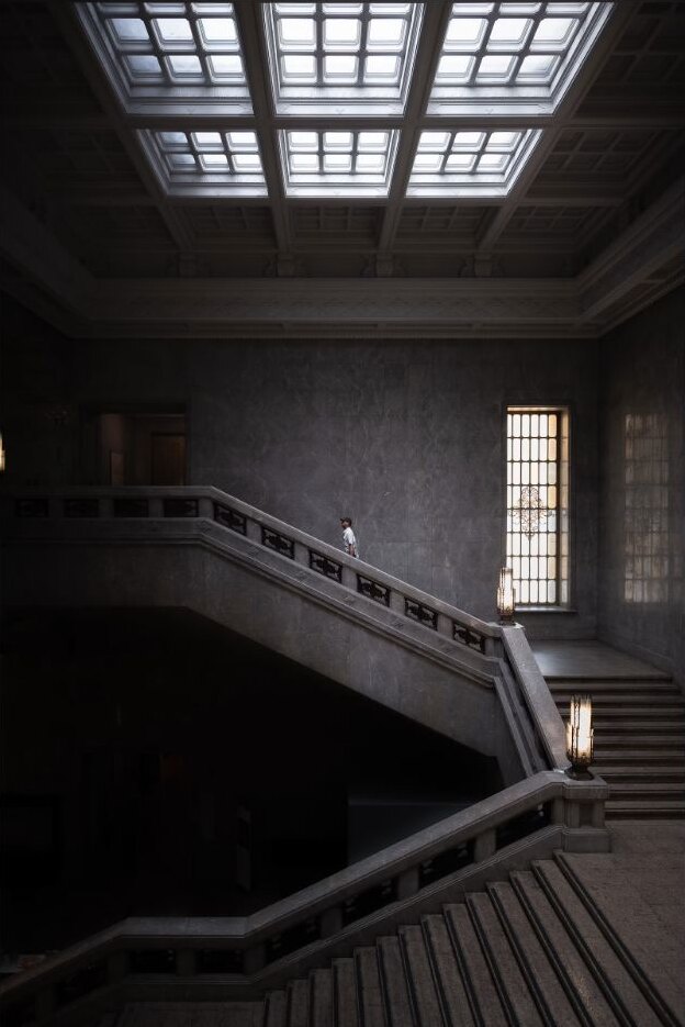 A visitor descending stairs inside the Tokyo National Museum